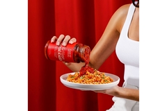 Image Pourring sauce on pasta.
